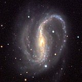 An elliptical (left), a spiral (centre) and an irregular-shaped galaxy